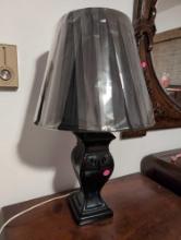 (BR1) BLACK CERAMIC TABLE LAMP WITH BLACK PLEATED SCALE. IT MEASURES 21-3/4"T.