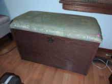 (BR2) WOODEN LIFT TOP TRUNK WITH GREEN FLORAL UPHOLSTERED TOP & BRASS HINGE ON THE FRONT. TWO