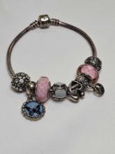 Sterling Silver Pandora Bracelet with pink charms. Weighs 44.5 grams and measures approx. 7.5