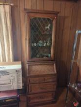 (LR) WOOD CURIO FALL FRONT DESK, 1 UPPER DOOR WITH 2 GLASS SHELVES, THE DESK IS OVER 3 DRAWERS, 25