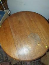 34" x 34" round wooden table - sides fold down. Decorative legs. Sold as-is.
