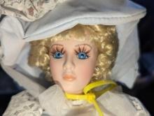 (GAR) Blonde Hair and Blue Eyed Porcelain Doll Wearing a Blue Dress with White Lace Accents and