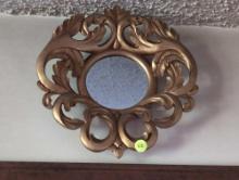(KIT) ROUND FOLIAGE DETAILED GOLD PAINTED WOOD MIRROR. IT MEASURES 11"W X 12"T.