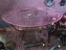 (DEN) VINTAGE RED PAINTED WROUGHT IRON OVAL COFFEE TABLE. IT MEASURES 25-1/2"W X 17"D X 17"T.