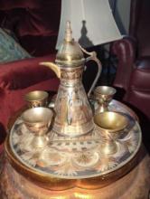 (LR) EGYPTIAN METAL DECORATIVE SERVING SET, 5 CUPS, 1 COFFEE POT, AND A SERVING PLATE.