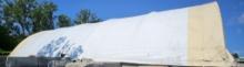 Large white and yellow tent top with poles 75-80 foot long roughly 60 foot tall