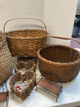 Baskets two watering cans and a wicker baby stroller