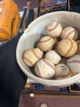 baseball bats, Louisville slugger bag, and bucket of baseballs