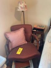 floor lamp, side table, cushioned chair, novels and magazines, alarm clock