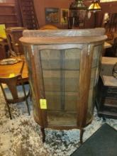 Antique oak glass door curio with curve glass sides and applied carvings