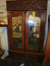Antique oak knock down cupboard with mirrored doors, drawer and applied carvings