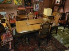 Vintage table with 4 cane back chairs, heavily carved on base