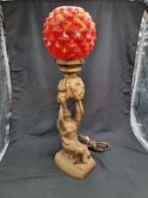 Art Deco metal spelter lady holding up globe with colorful shade