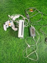 nintendo wii with cords and accessories