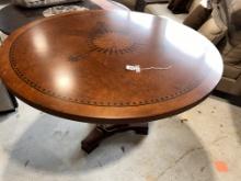 Round Dining Table in Mirtle Burl with black design inlay. Wood and bronze base