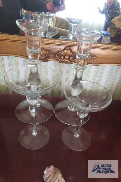 Two sets of clear glass candleholders