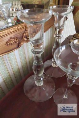 Two sets of clear glass candleholders