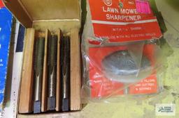 lot of taps, saws and lawn mower sharpener
