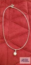 Silver colored pearl-like pendant, marked 14K on silver colored chain, marked 14K, approximate total
