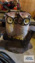 concrete owl figurine in basement