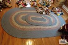 Two blue braided rugs, one just a throw rug and other room size