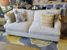 Clean light color 2 cushion sofa with accent pillows